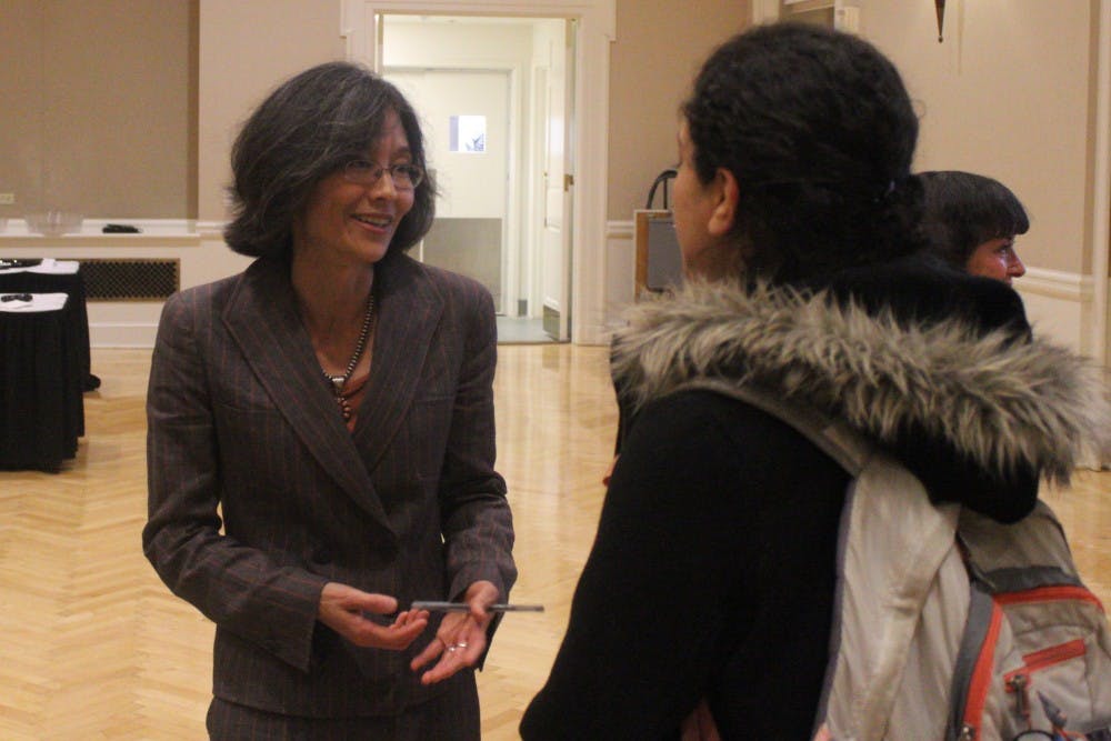 Dr. Sonya Shin speaks with a student during the Center for Global Health Research Symposium.