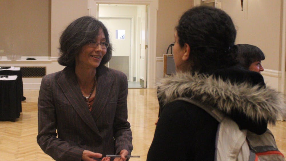 Dr. Sonya Shin speaks with a student during the Center for Global Health Research Symposium.