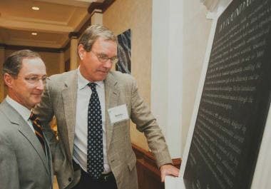 A plaque commemorates the dedication of the new building for the School of Medicine.