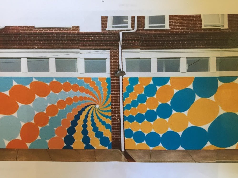 The finalized design is meant to serve as a backdrop for student photos.