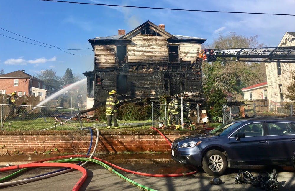 <p>Crews working to extinguish the fire at the home on Anderson Street Saturday afternoon.&nbsp;</p>