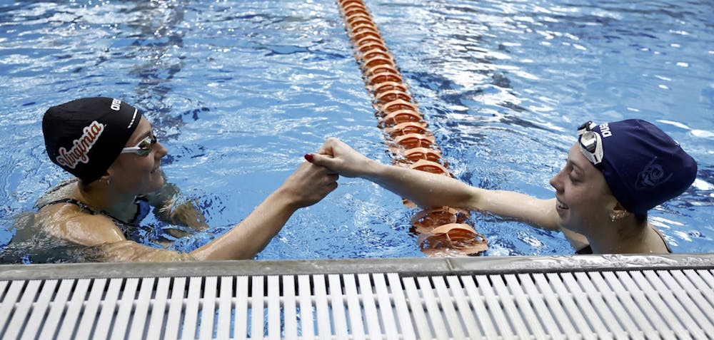 Alex Walsh and Gretchen Walsh celebrate after earning the top two finishes in the 100-yard breaststroke.