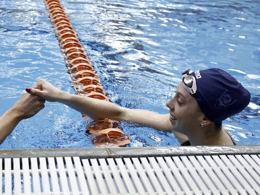 Alex Walsh and Gretchen Walsh celebrate after earning the top two finishes in the 100-yard breaststroke.