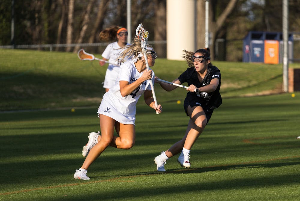 <p>Schwab makes a move on a VCU defender during Virginia's 16-8 victory April 3. &nbsp;</p>