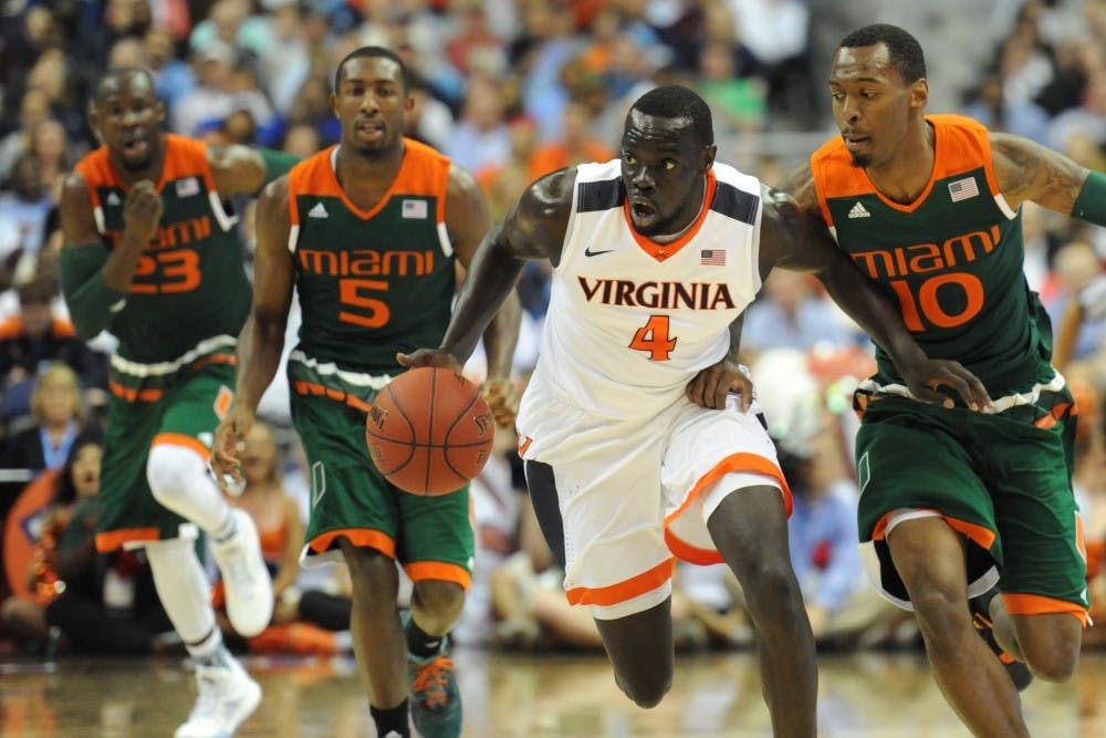 Members of the University men’s basketball team began posting a photo to social media Thursday night depicting 16 teammates dressed in black and kneeling on the John Paul Jones basketball court with arms linked.