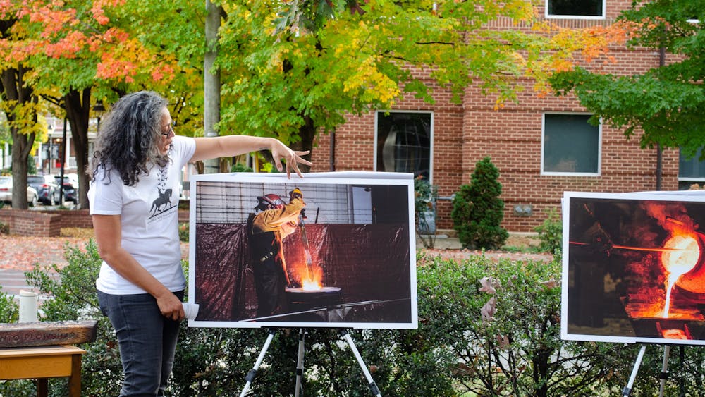 Event organizers unveiled blown up images from the melting process. One depicted the Confederate’s sword being thrust into the furnace.