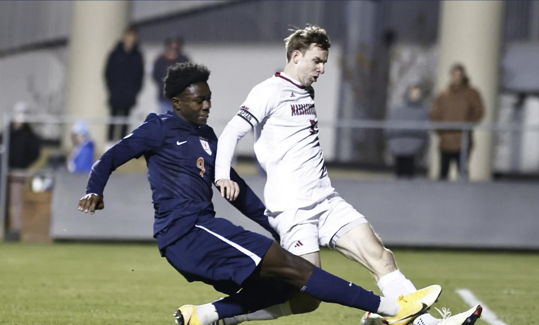AJ Smith battles a Massachusetts defender.