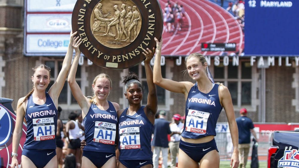 The women's DMR team hoists the wheel trophy.