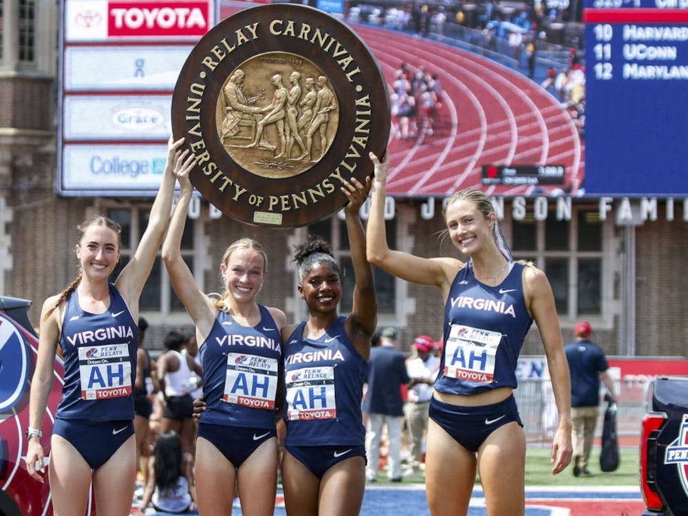 The women's DMR team hoists the wheel trophy.