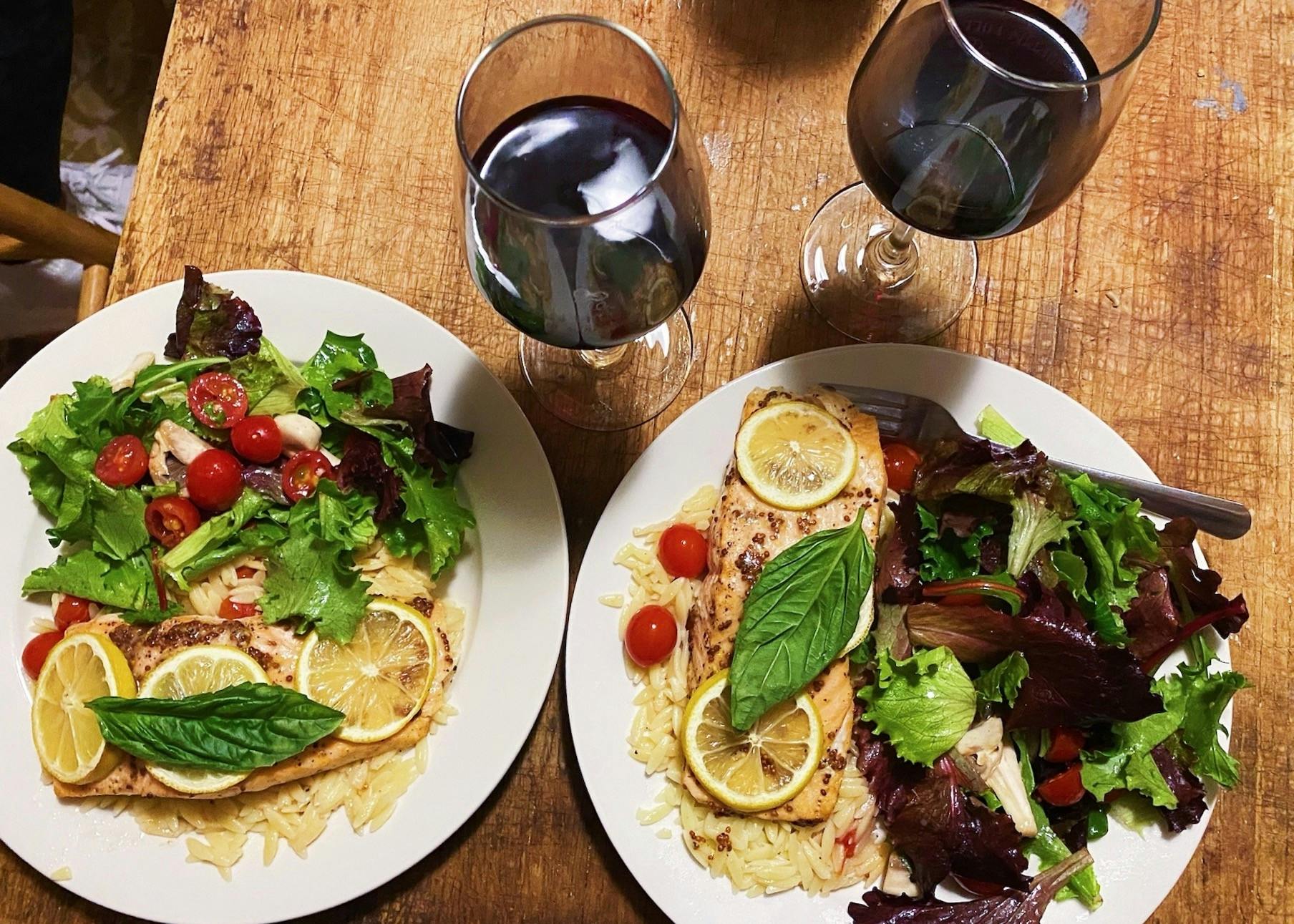 To plate this dish, lay down a bed of orzo pasta and place one piece of salmon on top.