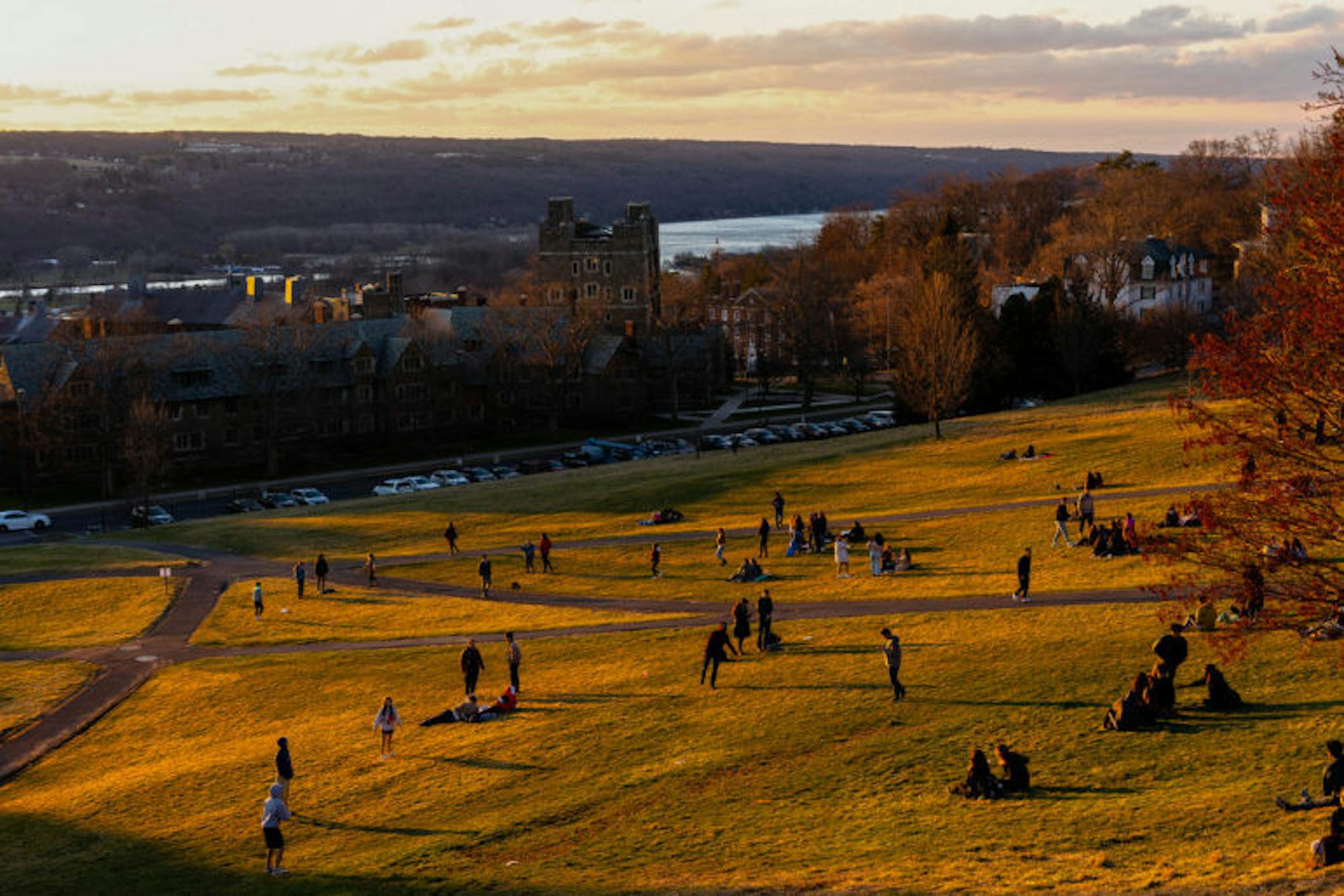 Students hung out on Libe Slope on Friday, soaking in the warm weather after receiving President Pollack's announcement about the latest status of COVID-19 and in-person classes on campus. (Harry Dang/Sun Staff Photographer)