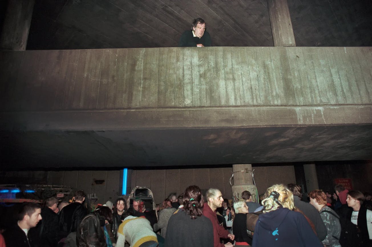 An angered resident vilifies London’s squat party attendees from an overpass.