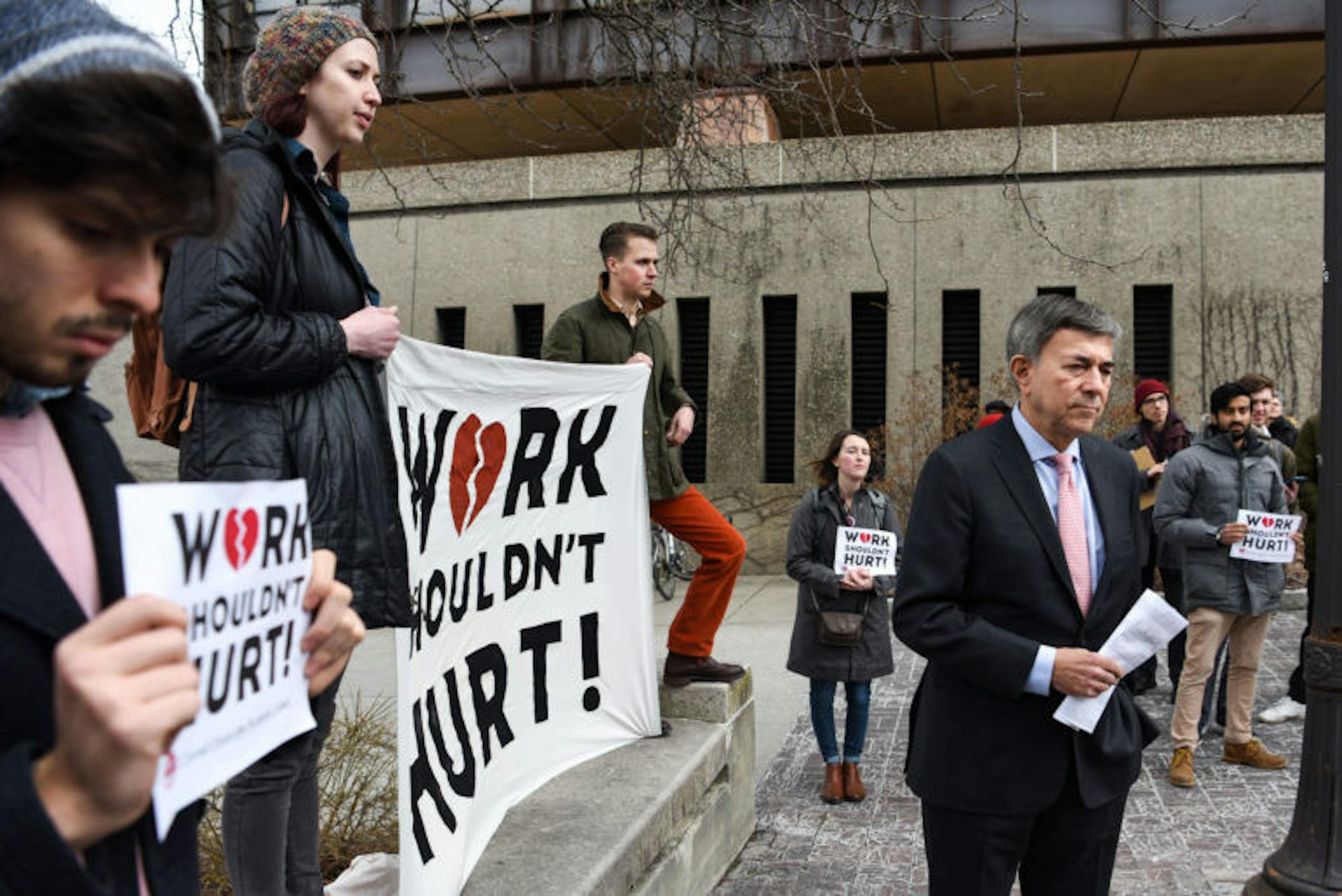 Robert Harrison, the chairman of Cornell’s Board of Trustees, and members of Cornell Graduate Students United listen to student testimonies about Cornell's mental health services at a rally Thursday afternoon. CGSU presented Harrison with a petition calling for institutional improvements to Cornell’s mental health programs. (Boris Tsang / Sun Photography Editor)