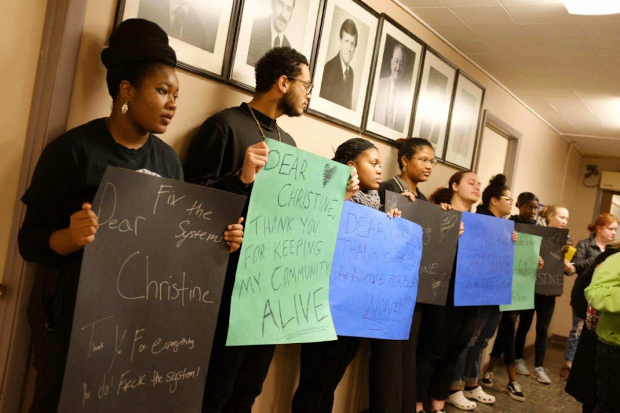 Ithaca College students and community members protest the termination of Christine Barksdale, an Ithaca Police Department investigator, at Wednesday's Ithaca Common Council meeting. (Michael Suguitan/Sun Staff Photographer)