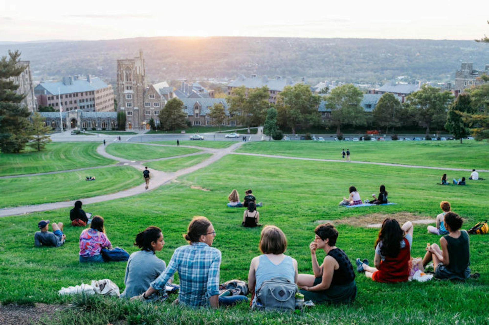 Students take advantage of the warmth and use the area on Libe slope to study and relax on Wedensday. (Michael Wenye Li / Sun Photography Editor)