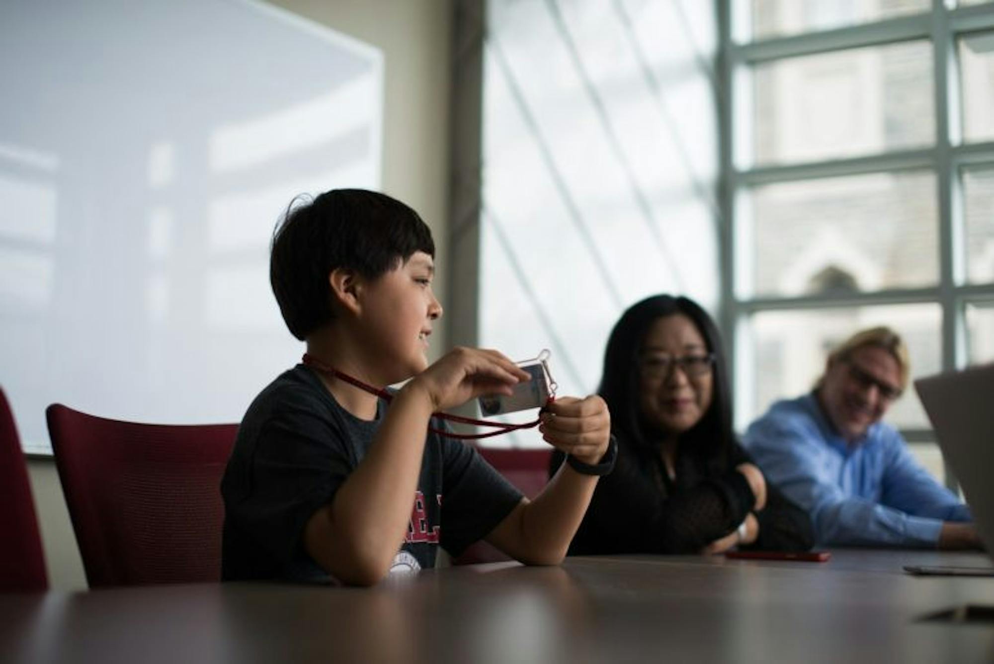 Jeremy Schuler '20 participates in an interview in Statler Hall alongside his mother Harrey and father Andy.
