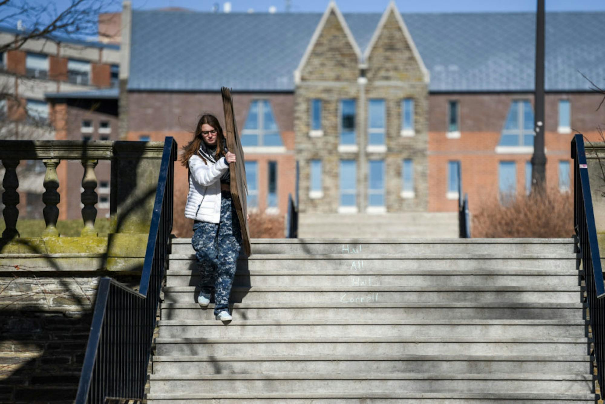 A student carries cardboard boxes from RPCC on March 15, 2020.