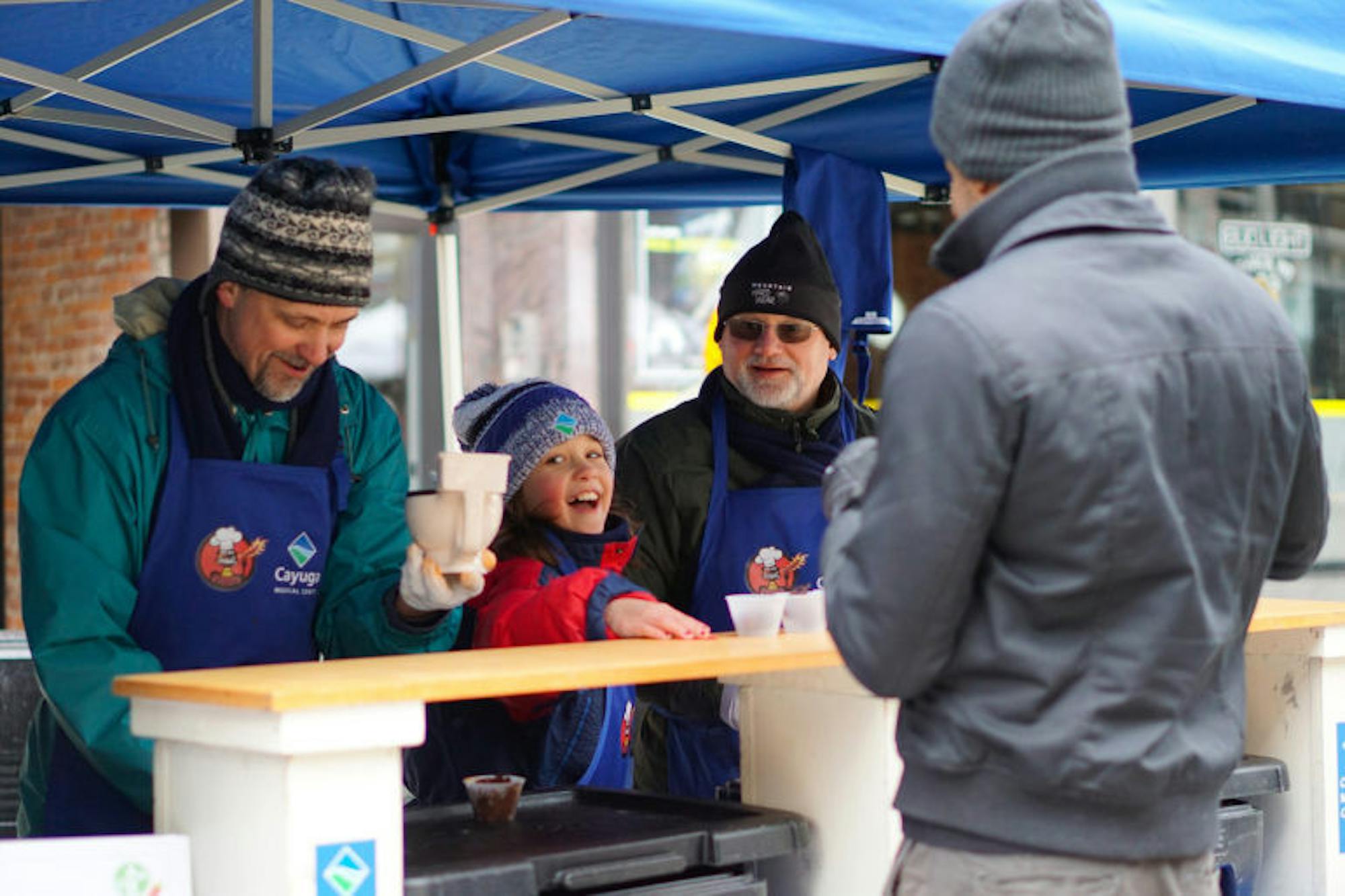 Attendees are served warm chili during the cook-off in downtown Ithaca.