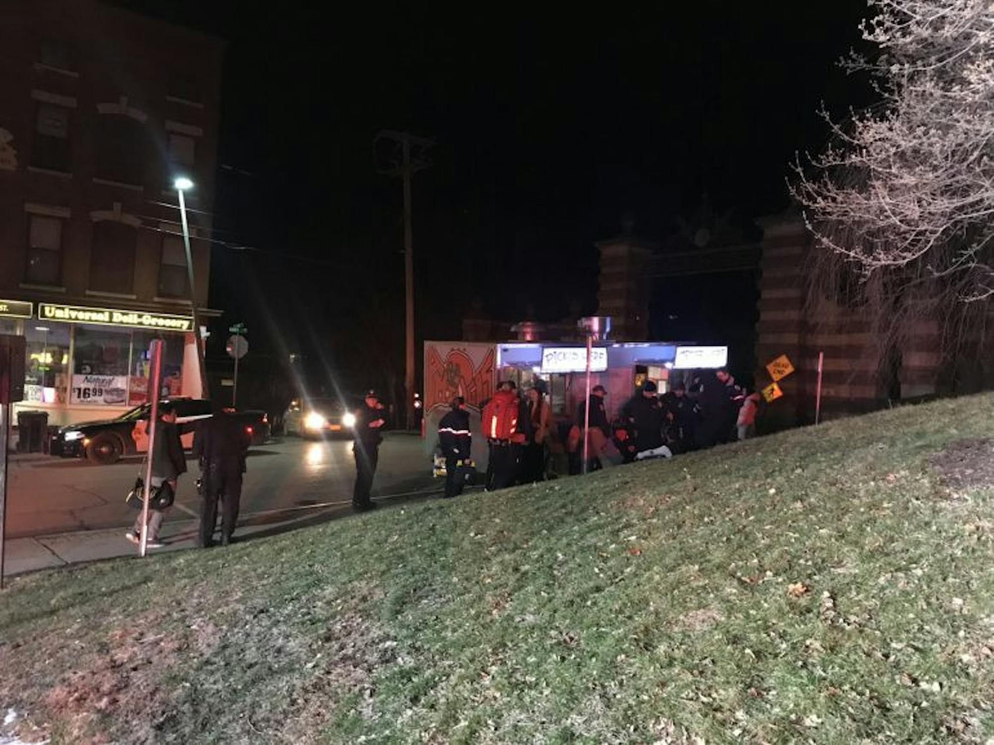 Emergency personnel treat a victim's injuries and interview witnesses next to the food truck on Eddy Street early in the morning on Saturday, March 10, 2018.