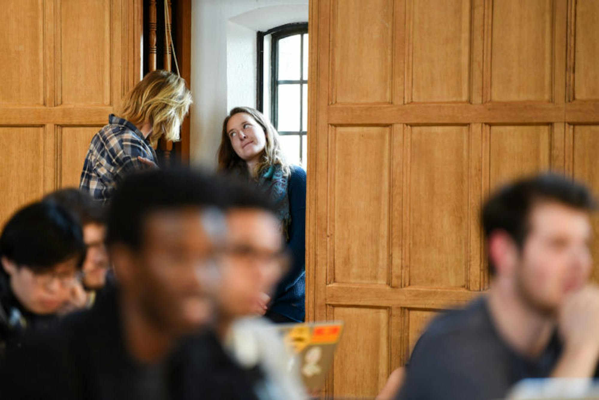 An audience member reacts to the debate at the Student Assembly Meeting on Thursday. SA members spent three hours arguing over whether or not to reinstate presidential candidate Varun Devatha ’19 after the judicial codes counselor, Kendall Karr, law ’18, concluded that the Elections Committee applied election rules in a biased manner.