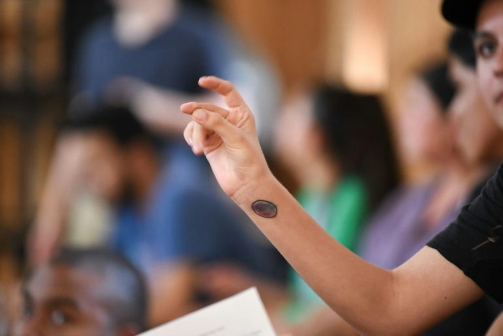 An audience member snaps in approval after a fellow student criticizes the new security fees. (Boris Tsang / Sun Assistant Photography Editor)