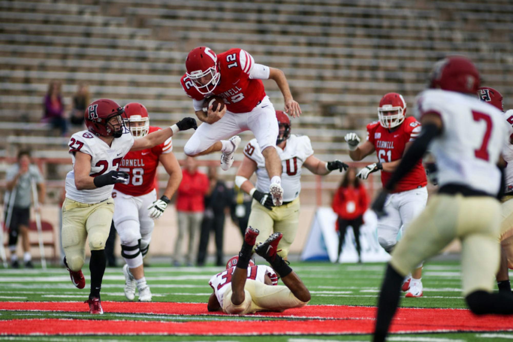 Junior quarterback Mike Catanese hurdles a defender for a gain in Cornell's win over Harvard. The Crimson successfully stymied the run for most of the game, but Catanese and Coles found some holes.