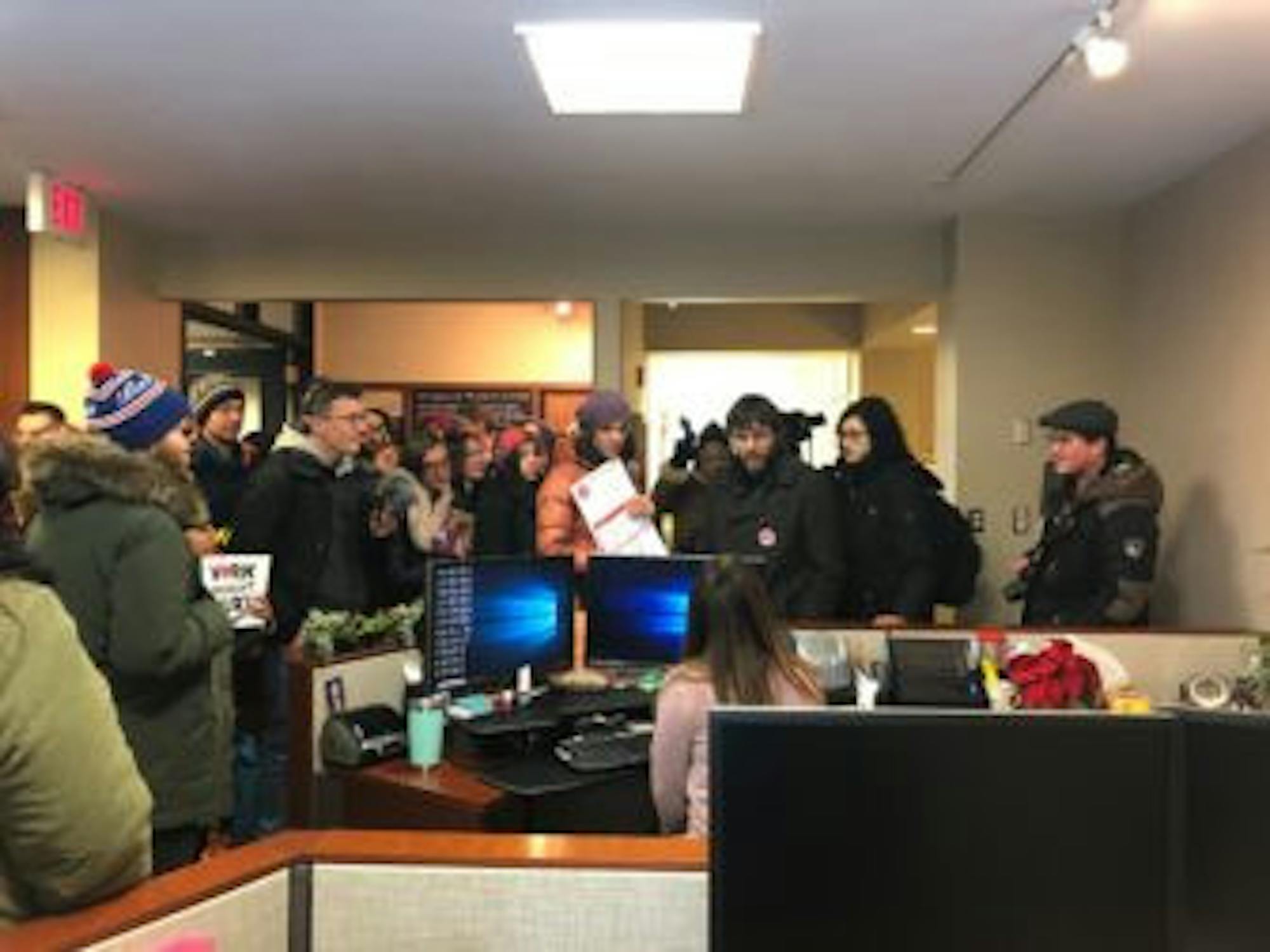 CGSU members crowded together on the third floor of Day Hall to deliver their petition.