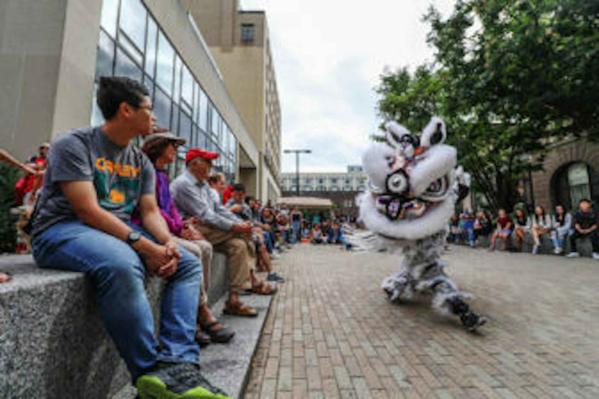 Attendees are approached by a Chinese dragon at the C.U. Downtown celebration.