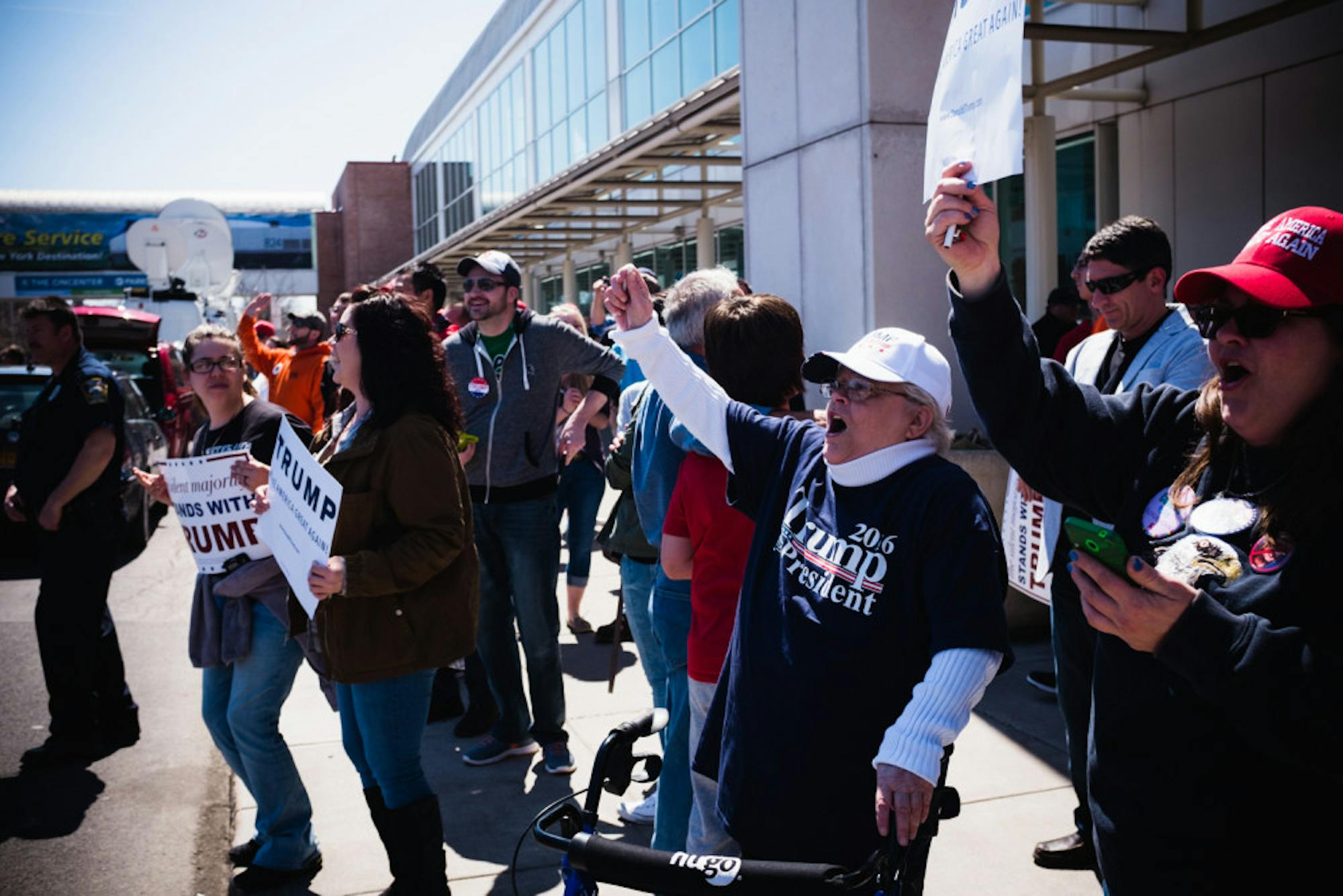 Trump fans shout across at protestors outside the Oncenter Saturday.