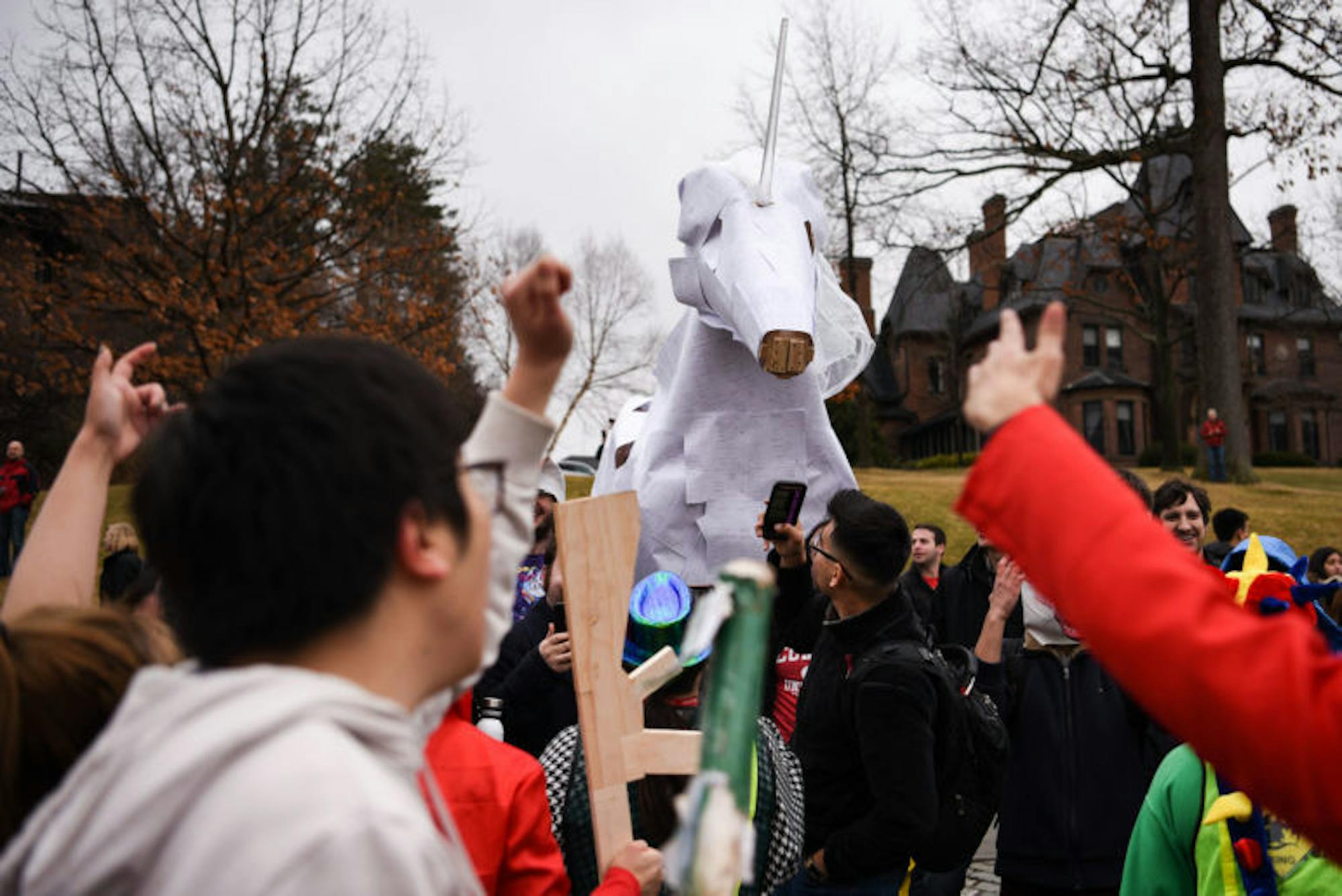 A unicorn, built by physics graduate students, greets paraders on East Ave. The unicorn has been a part of the parade since the early 2010s.