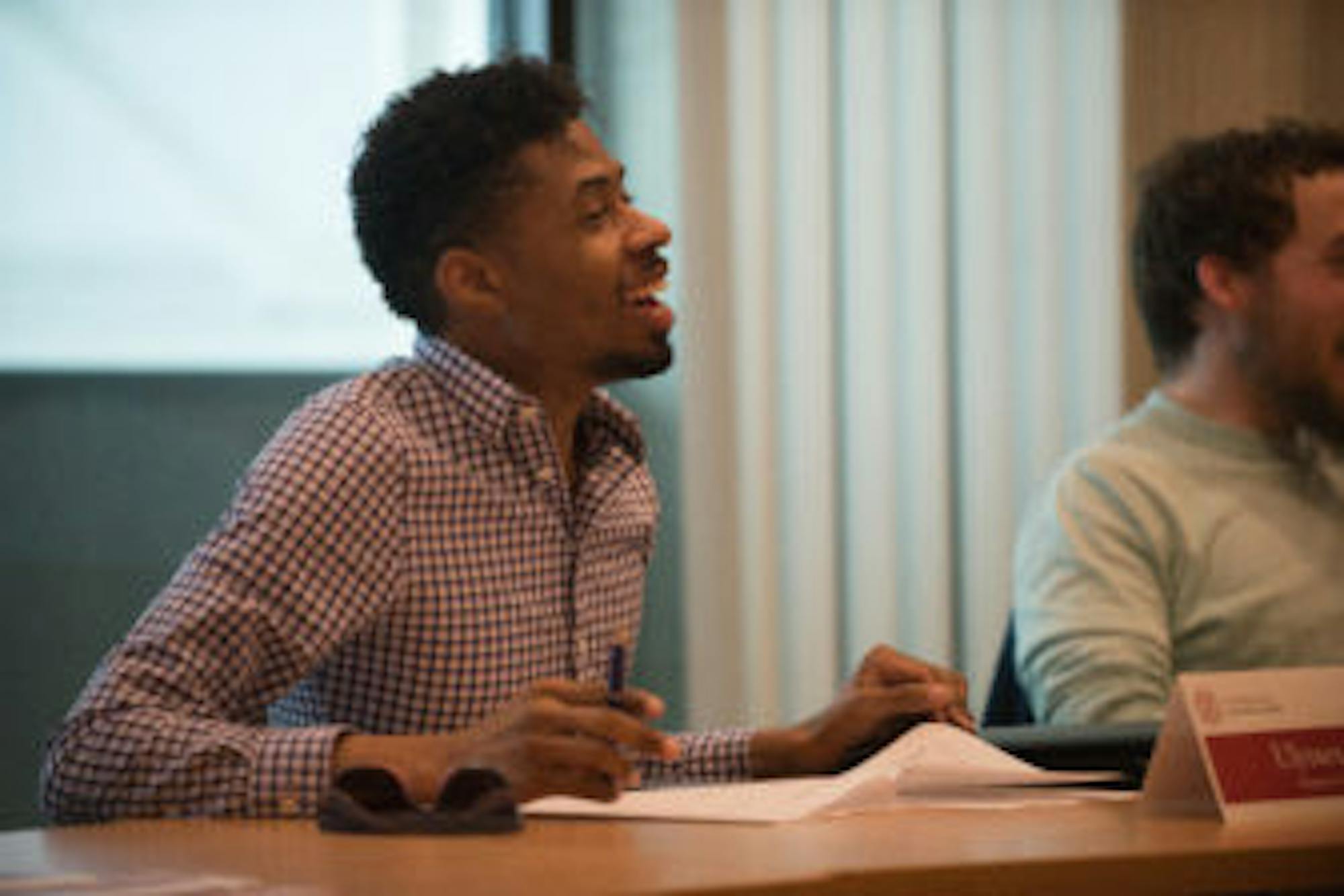 Ulysses Smith speaks at the University Assembly meeting Tuesday. Smith, chair of the Employee Assembly and a member of the Campus Welfare Committee, sponsored the resolution that would launch a process to make Cornell a tobacco-free campus in two years.