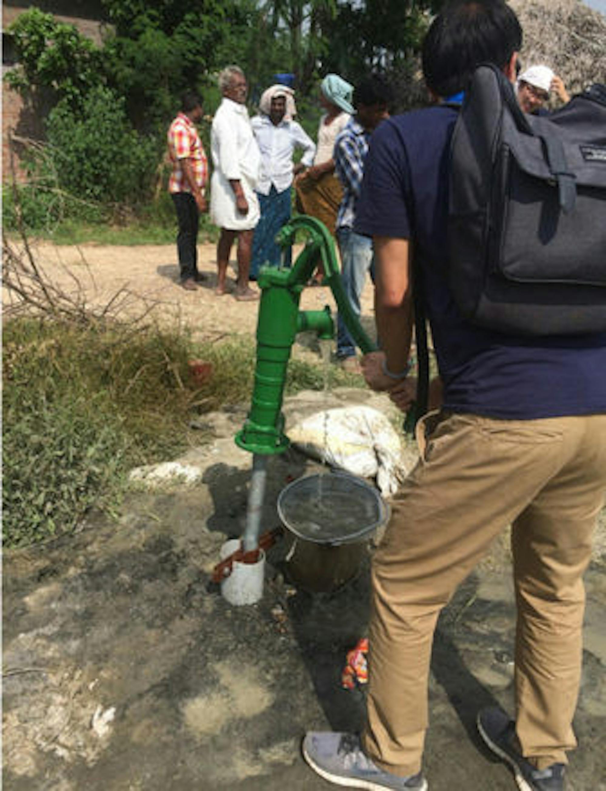 Team members stand in Pallapatla, where the team plans to implement the water quality control system.