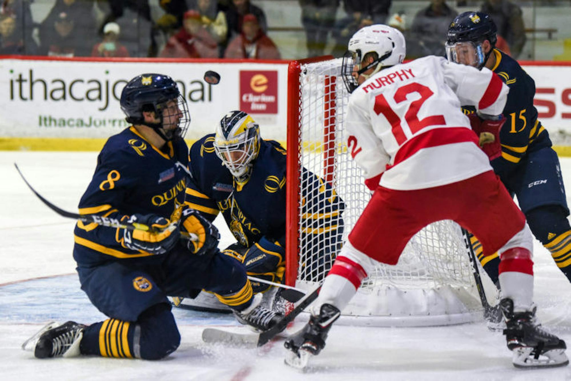 Junior forward Connor Murphy's shot is deflected at the men's hockey game against Quinnipiac on Friday. The Red suffered an unfortunate loss after a crazy bounce off of the glass put the Bobcats up 3-2 in the third period. (Boris Tsang / Sun Assistant Photography Editor)