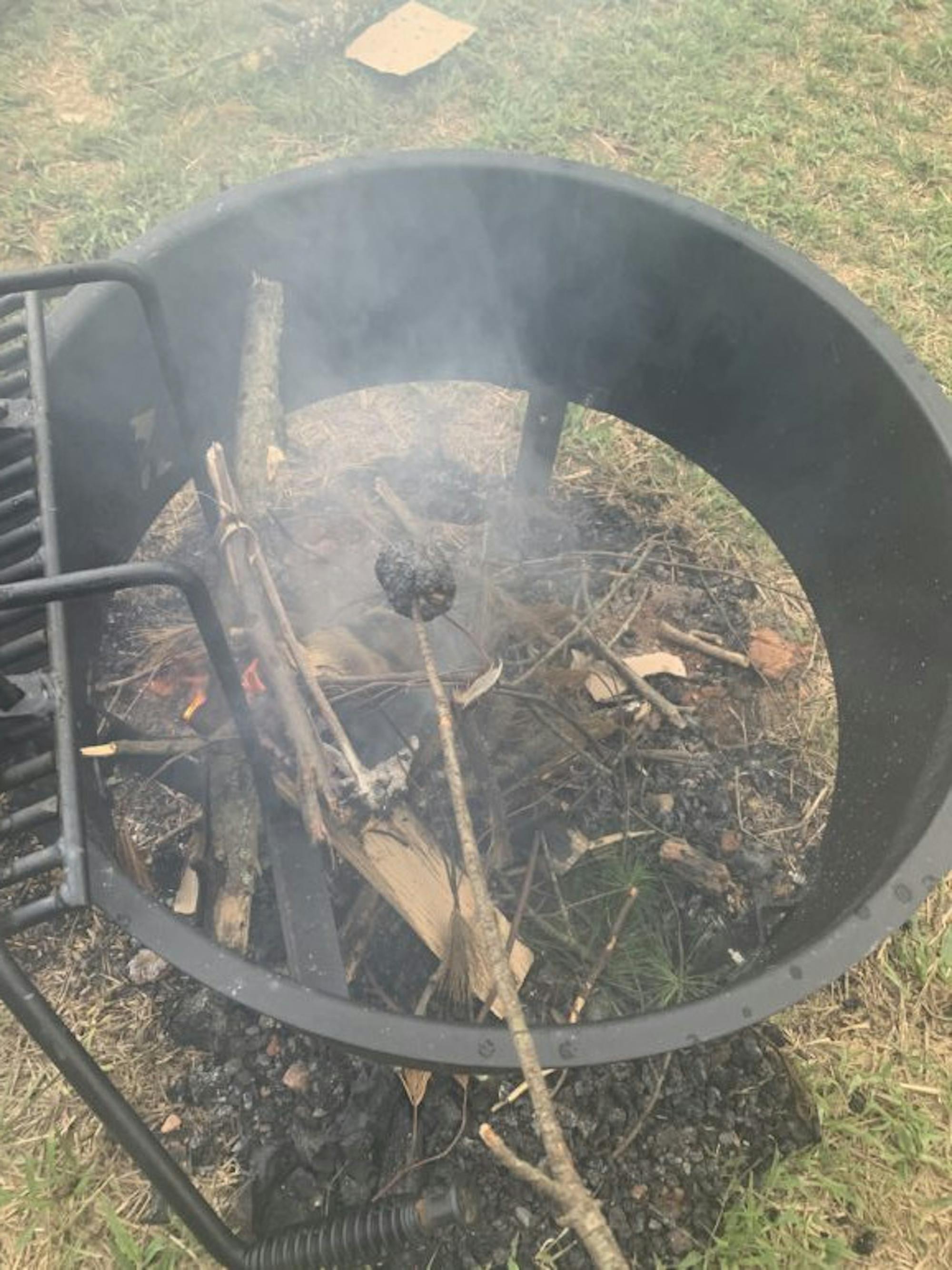Tending to outdoor cooking. (Sarah Austin, Sun Staff Writer)