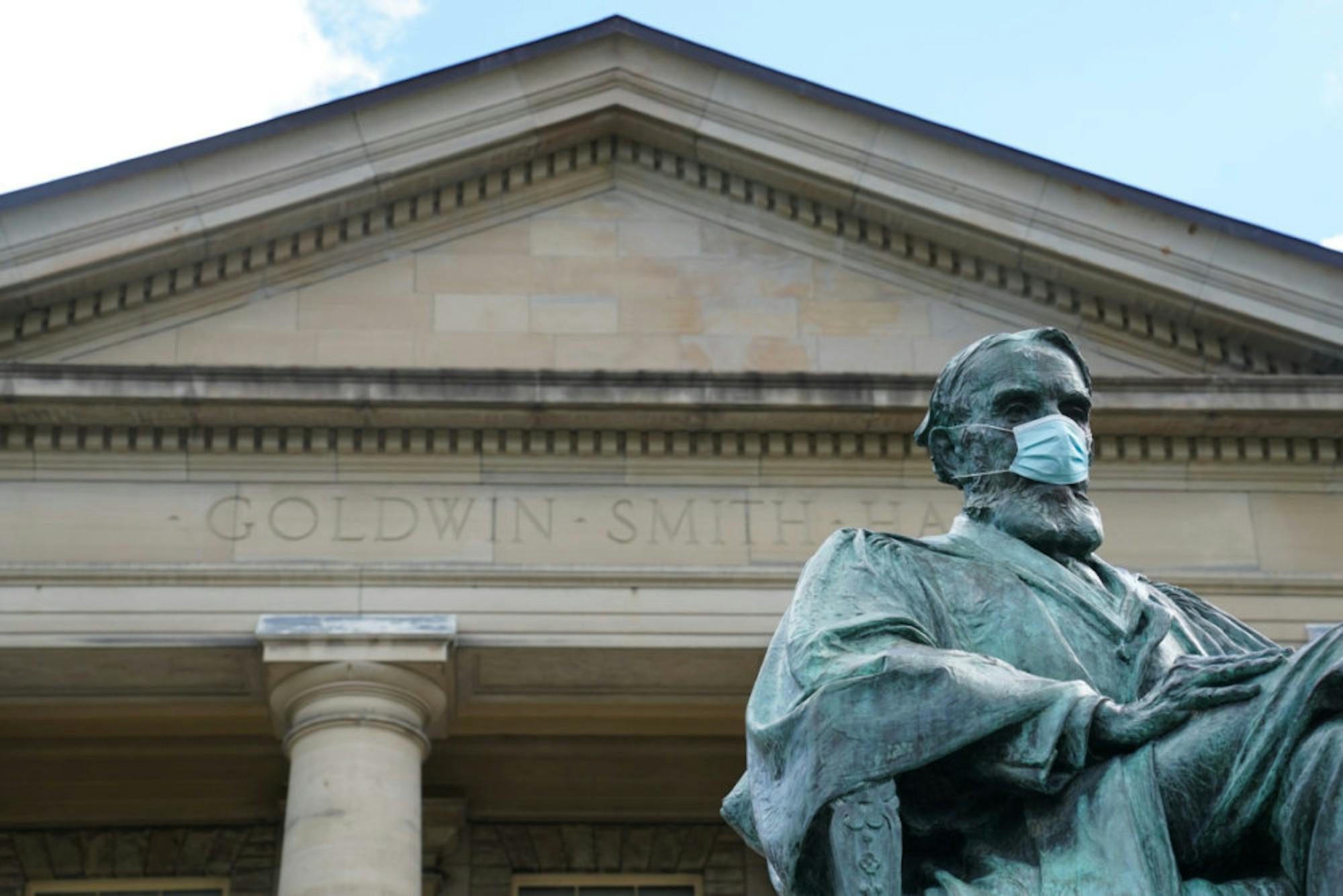 The A.D. White statue in front of Goldwin Smith Hall is outfitted with a mask. Life on campus is different, but Cornell's in-person plan has been one of the most successful in the country.