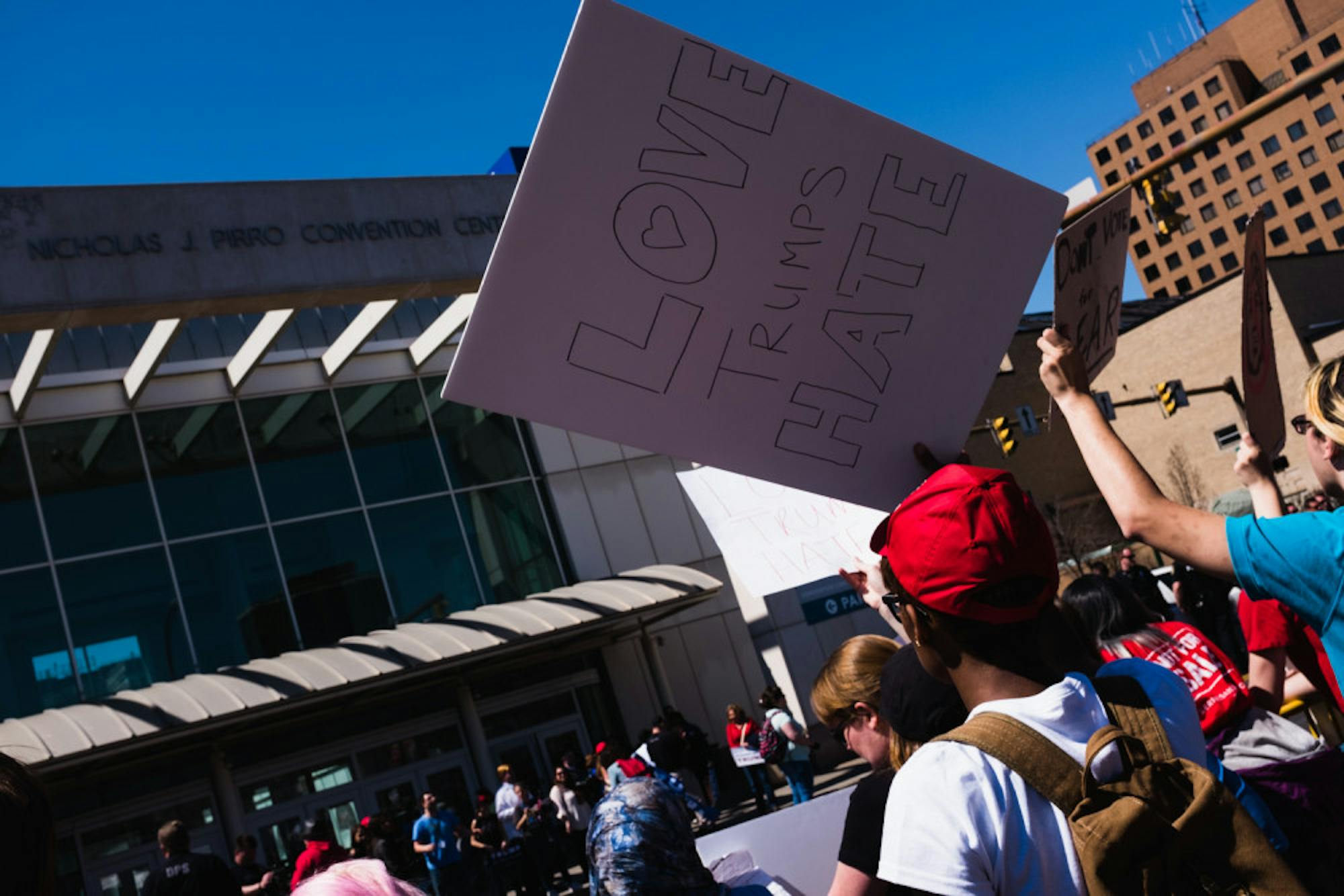 Protestors shout across the street at Trump supporters outside the Oncenter.