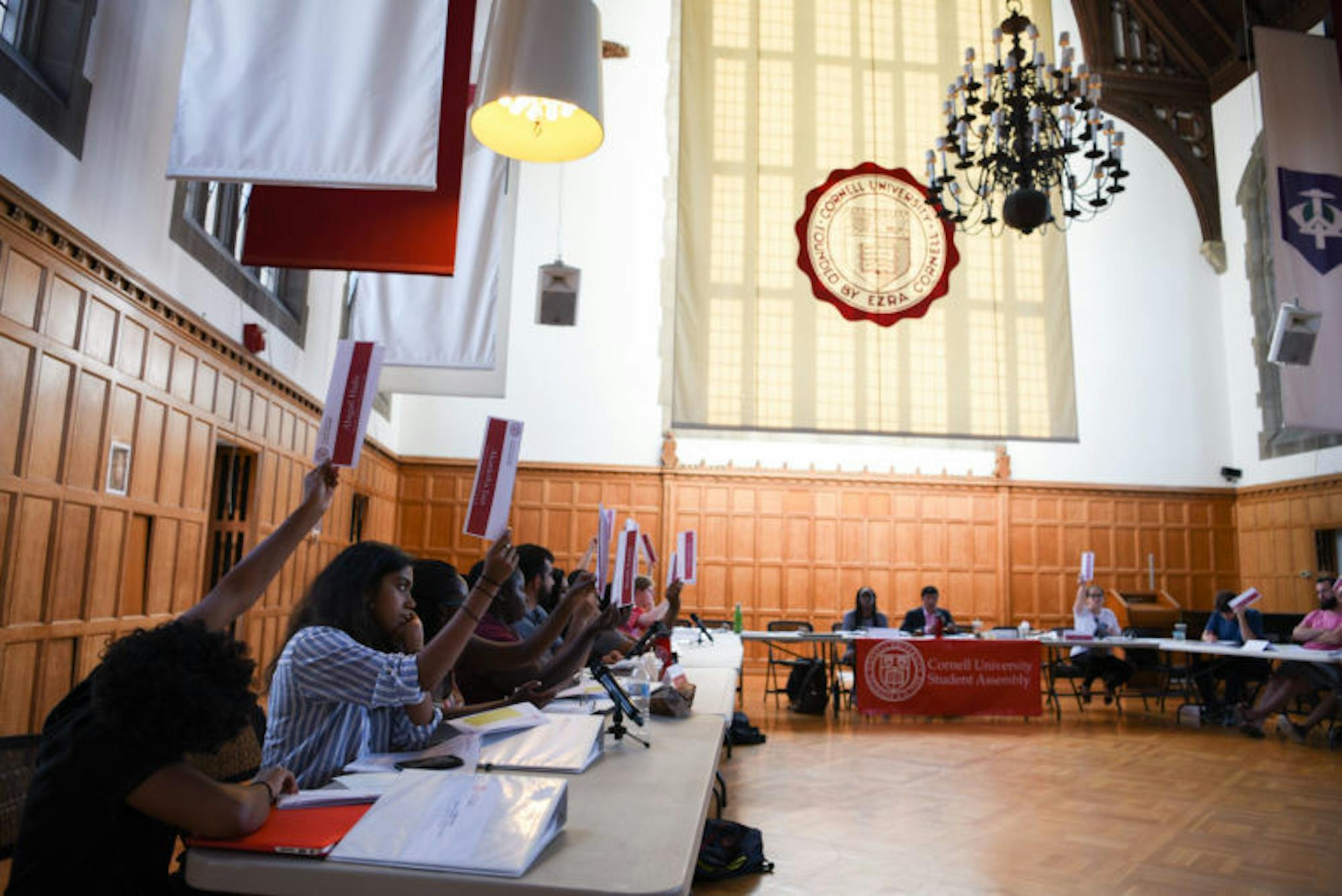 Student Assembly members vote on a motion at their meeting on Thursday. During the meeting, the S.A. amended its bylaws to allow for the creation of an auditory body aimed at disqualifying shell organizations from receiving SAFC funding; they also voted against adding a vice president of infrastructure to the S.A. executive board.