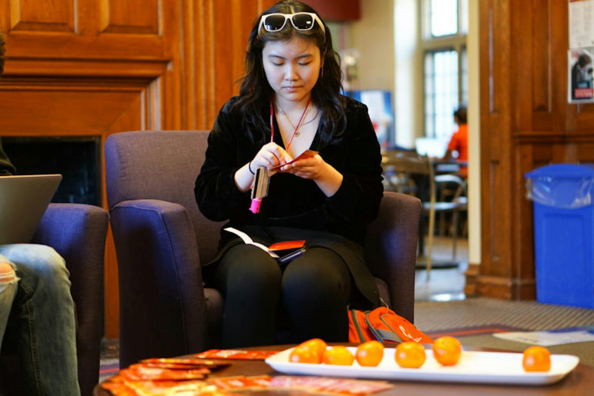 Caitlin Lau ’22 scratches her fortune card at the Lunar New Year Celebration at the Tatkon Center on Monday. (Michelle Yang / Sun Staff Photographer)