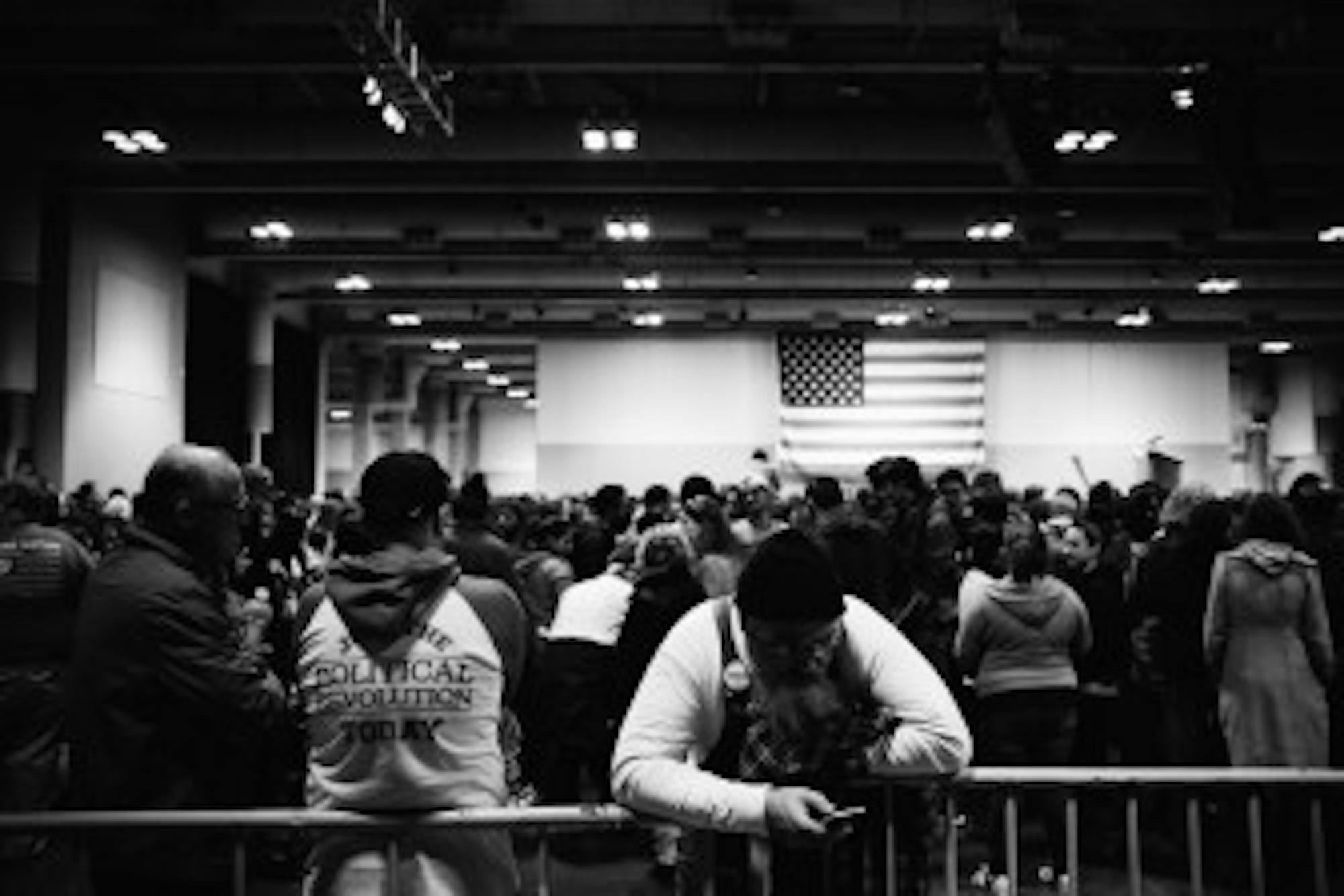 John Gazza, a Syracuse resident, leans against the fence at the rally.