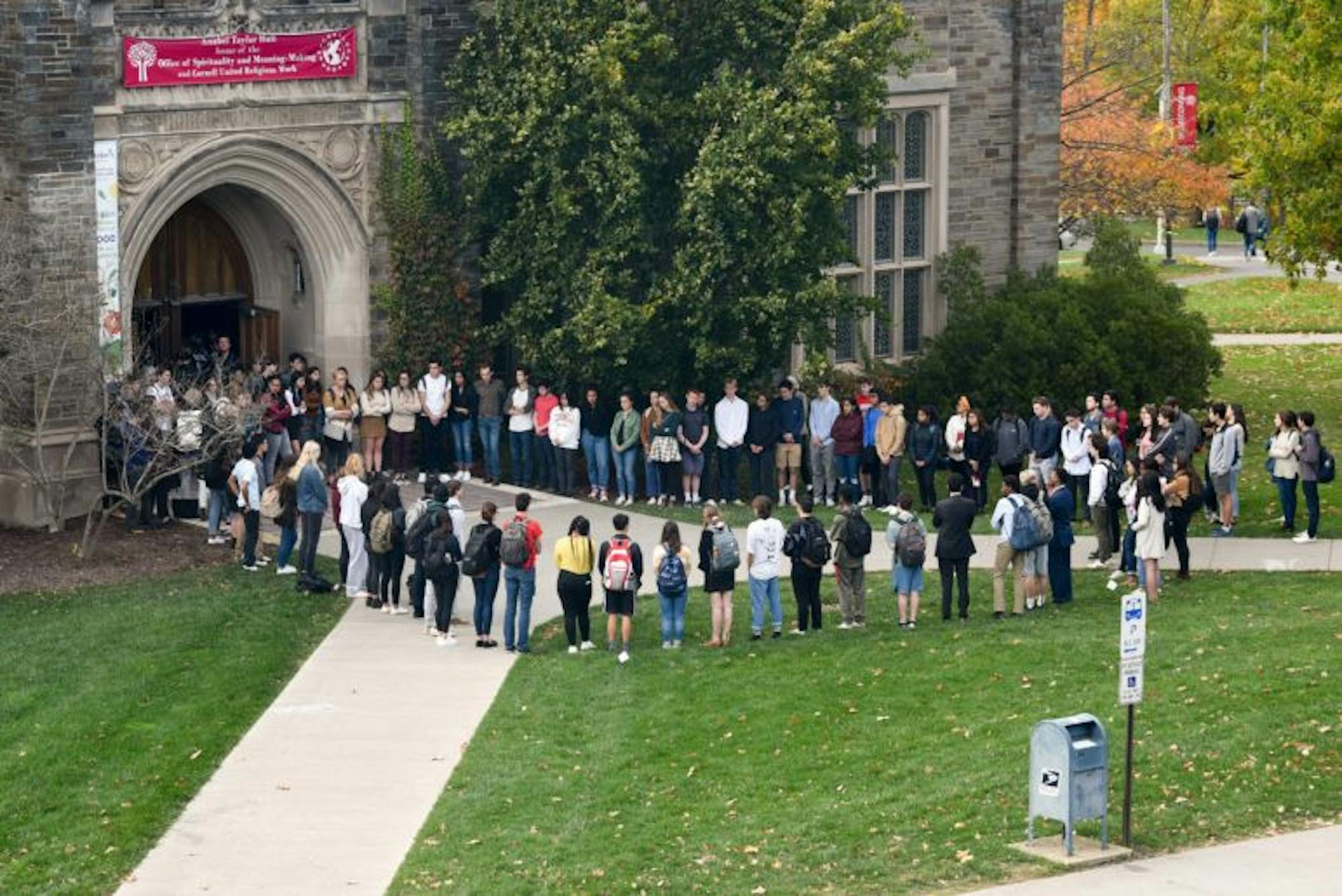 Students stand in a circle outside Anabel Taylor Hall during the service of remembrance for Antonio Tsialas '23 after the chapel was filled to capacity on October 29th, 2019.