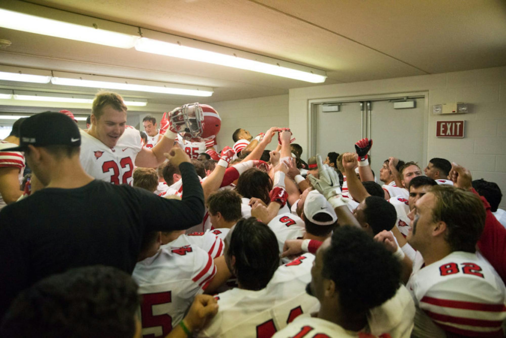 Cornell celebrates the win in the locker room after the game. After trailing 28-5 at one point, the Red came back to beat Colgate, 39-38.