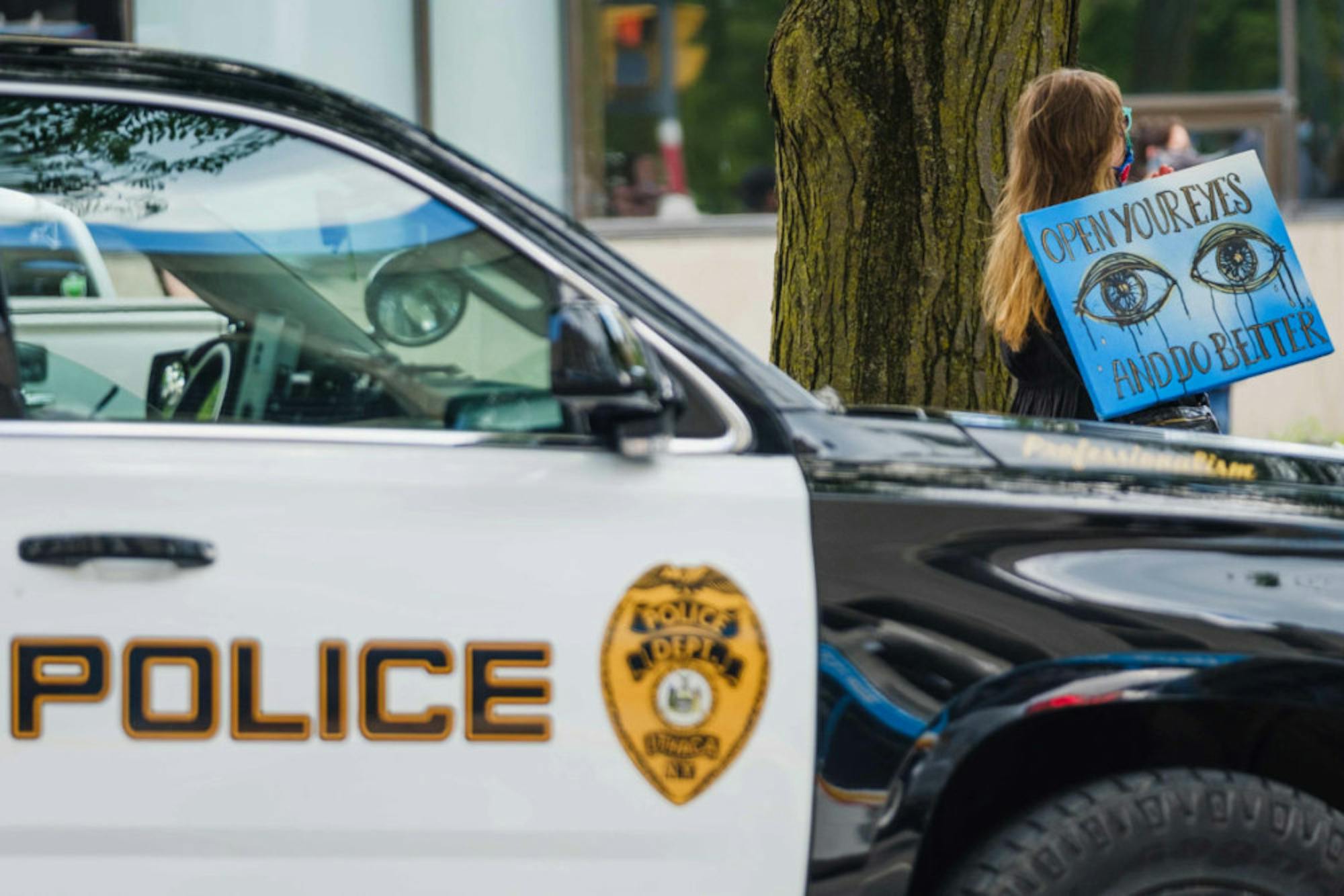 During the Uplift and Speak Out! rally, police cars dotted the streets. Calls for police reform filled posters, chants, and speakers' messages. (Michael Suguitan / Sun Staff Photographer).