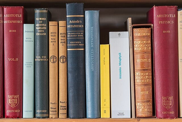 Part_of_a_bookshelf_containing_books_by_Aristotle_1