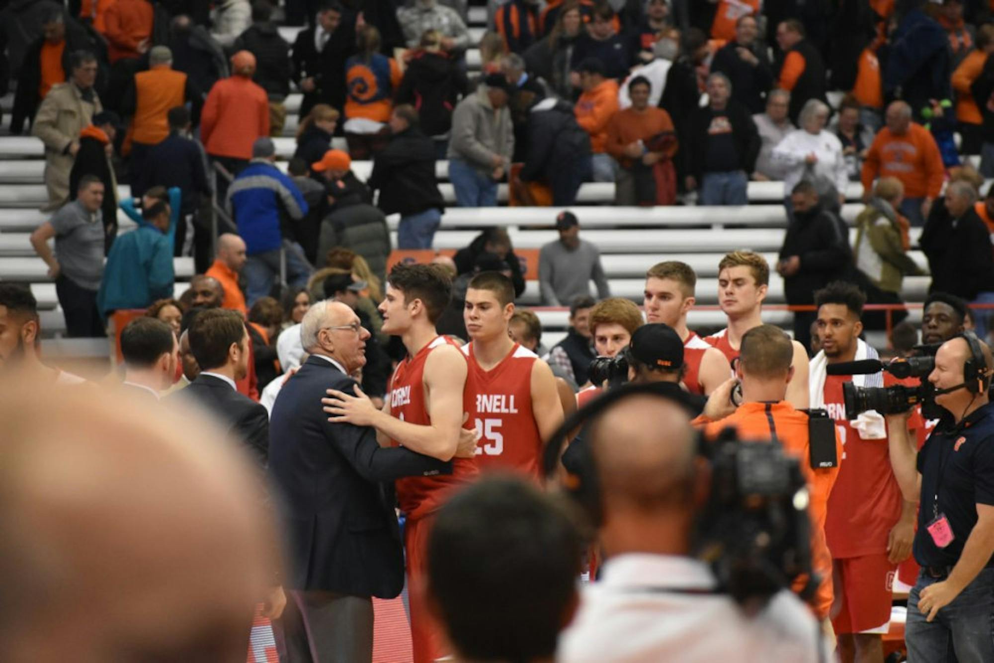 Cornell freshman forward embraces his father, Syracuse head coach Jim Boeheim, after the 77-45 Orange win Saturday night.