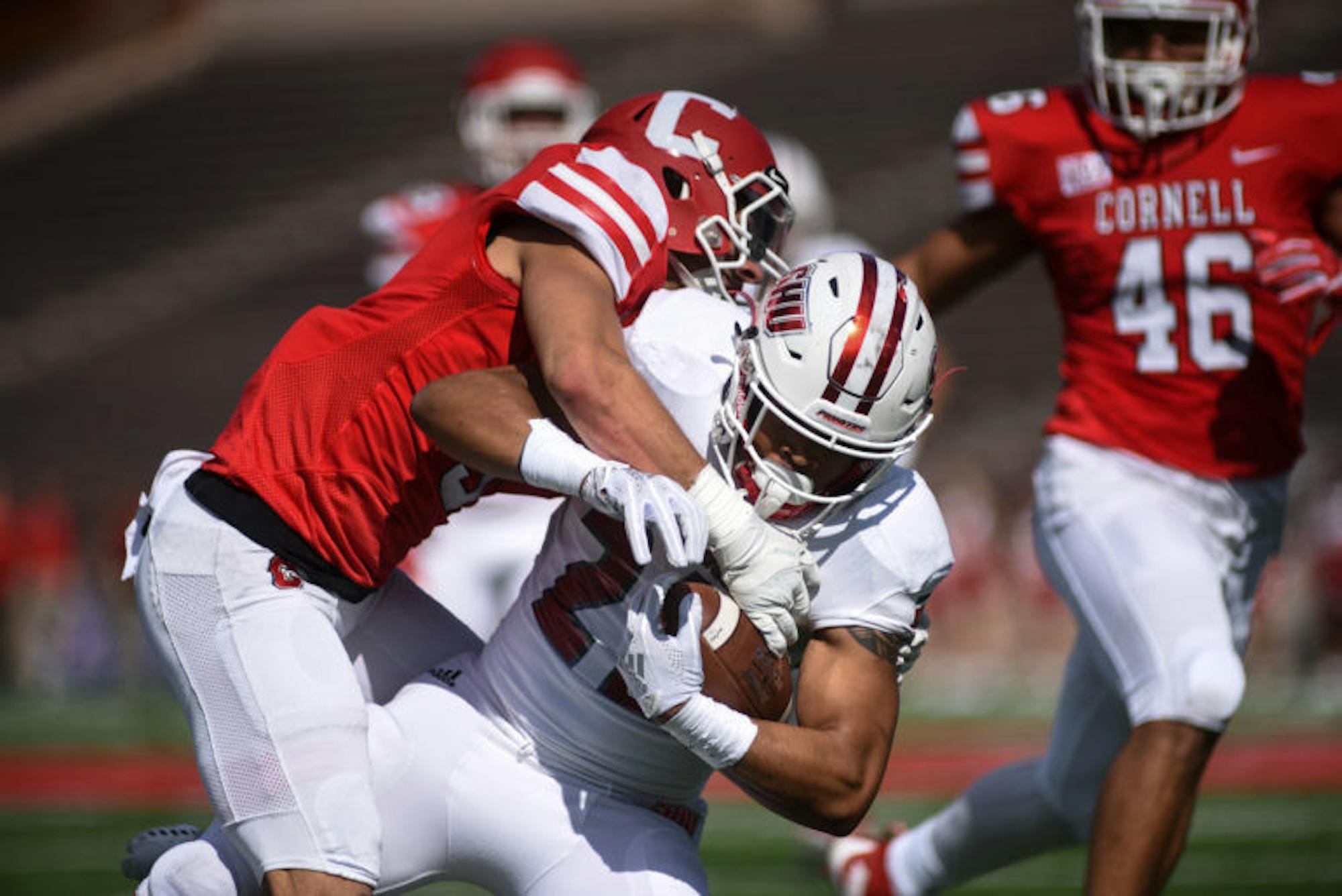 Senior safety Jake Watkins takes down the ball carrier at Saturday's game against Sacred Heart University. The Red claimed its first victory of the year in stellar fashion, with six different players scoring touchdowns throughout the game. (Boris Tsang / Sun Assistant Photography Editor)