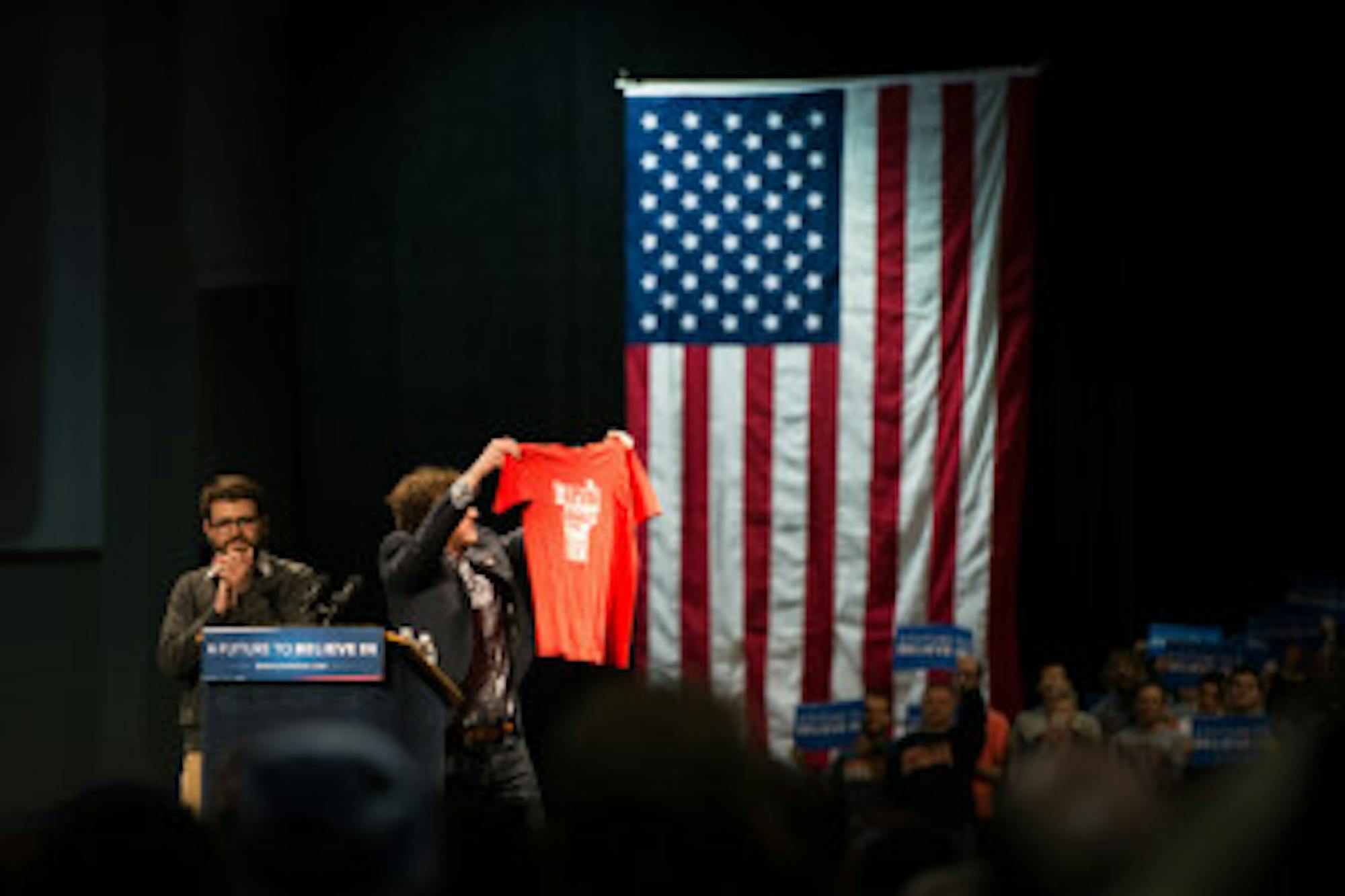 Zach Silver shows the crowd a shirt from his 2006 campaign to get Bernie Sanders elected to the senate.