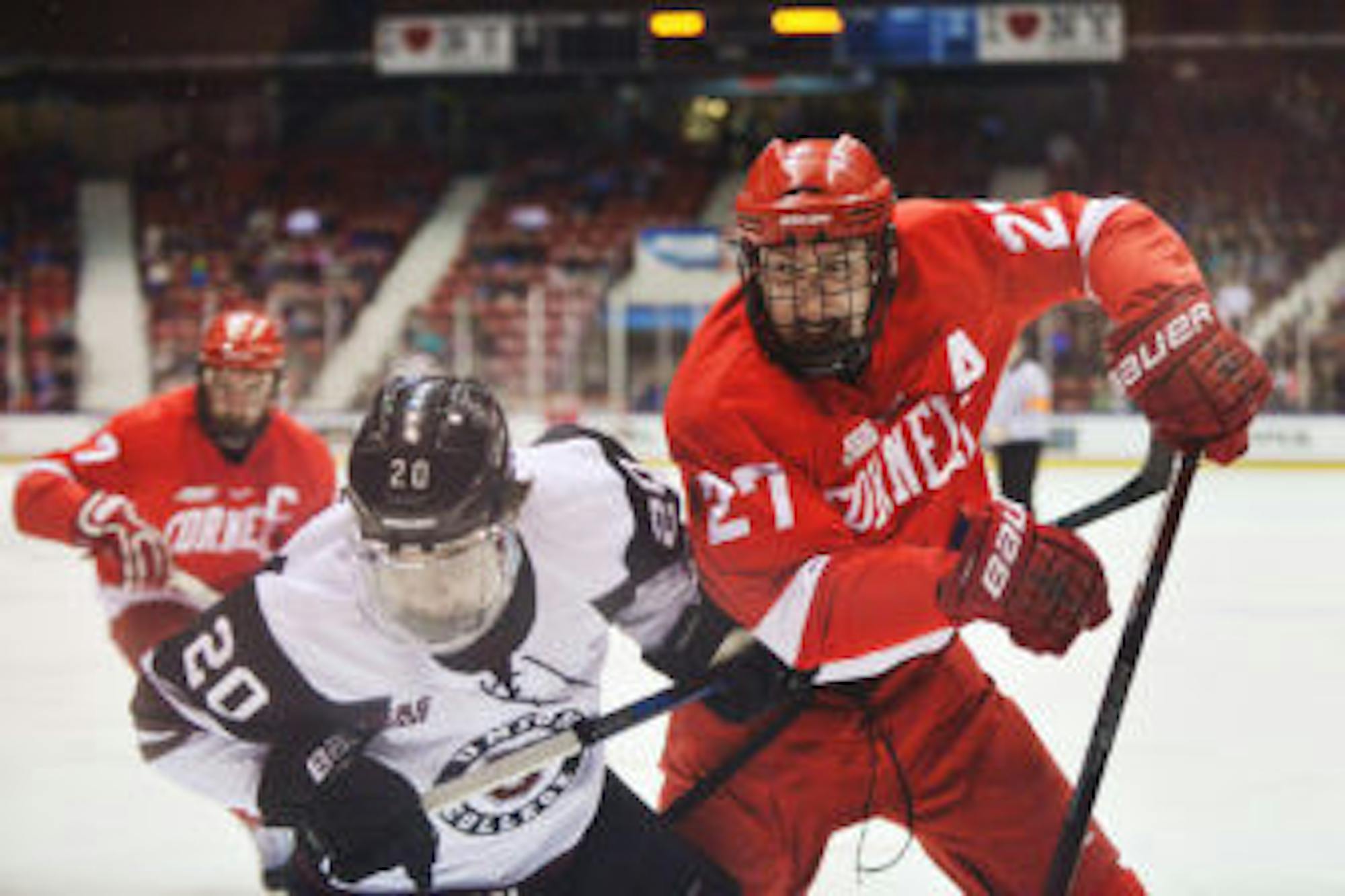 Senior Defenseman Patrick McCarron fights for the puck during the Red's Friday night match against Union in Lake Placid. (Cameron Pollack / Sun Photography Editor)