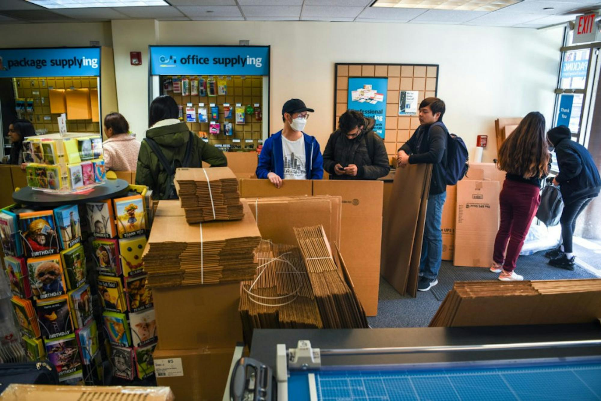 Students line up to buy cardboard boxes at the UPS store in Collegetown after President Martha E. Pollack announced that the University would suspend all classes as of 5 p.m. on March 13, 2020.