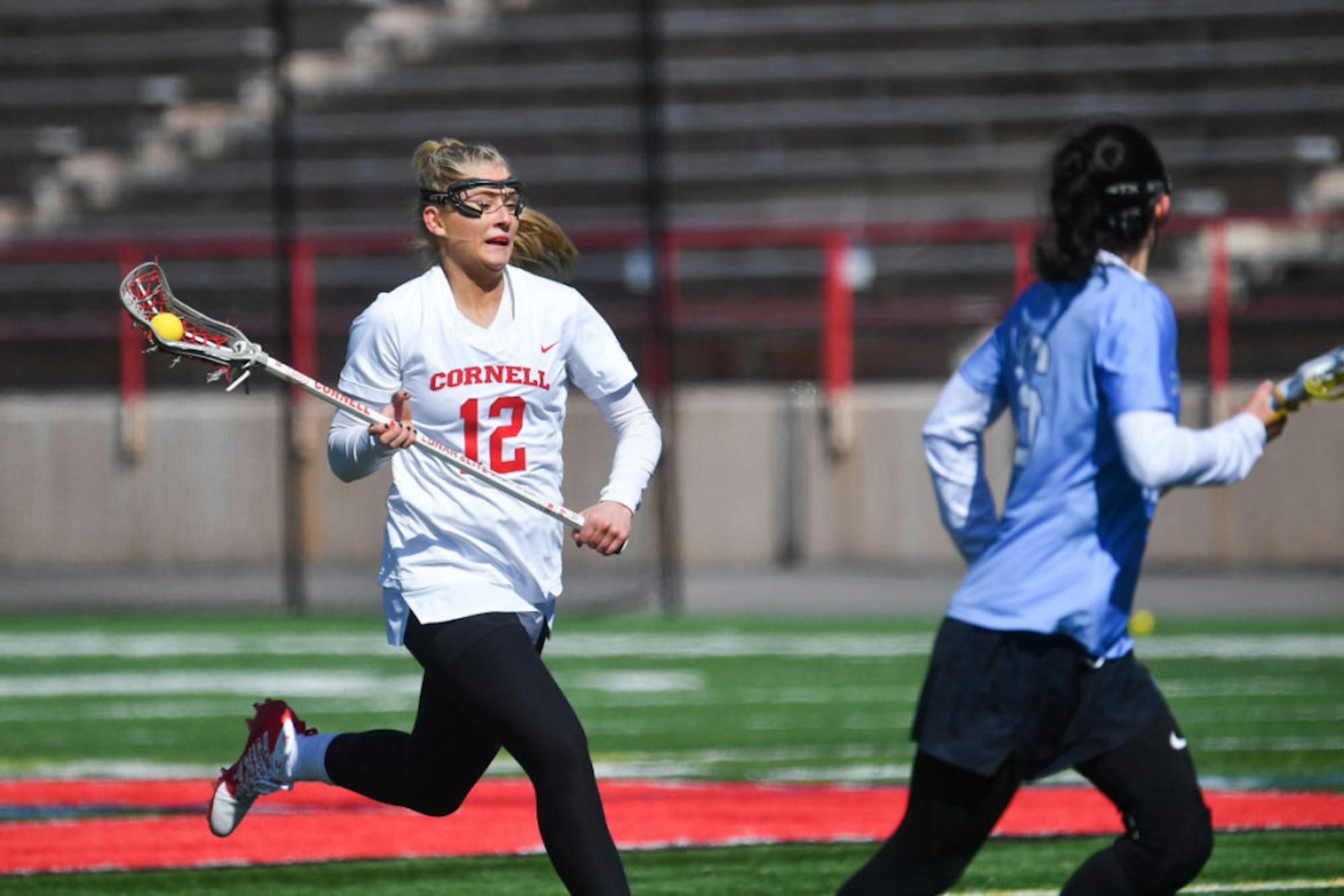 Freshman midfield Hilary Hoover runs with the ball at the women's lacrosse game on Saturday. Cornell took home the 20-2 win. (Ben Parker/Sun Assistant Photography Editor)