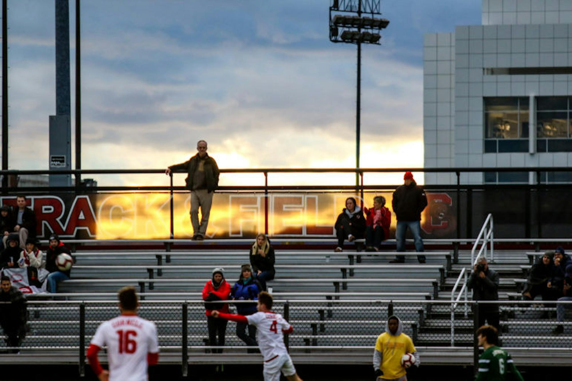 The sun sets over Berman Field as the men's soccer team takes on Dartmouth. (Michael Wenye Li / Sun Photography Editor)